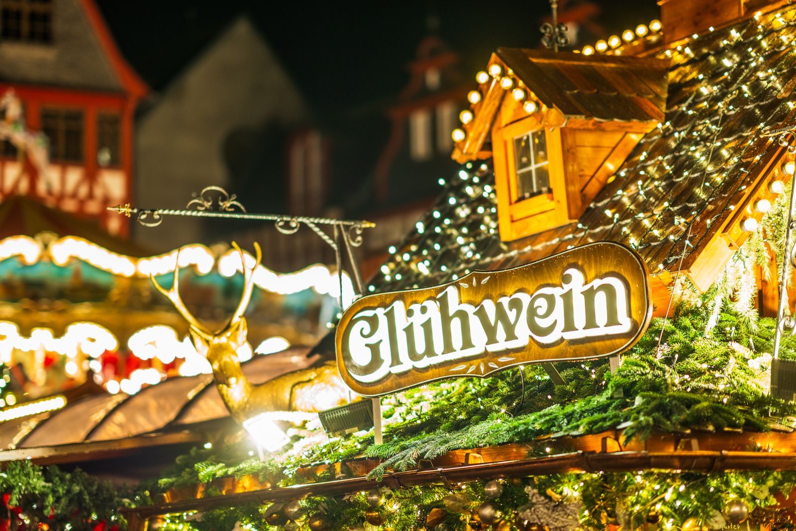 Glühwein stall glowing with lights at a German Christmas market, a taste of a Christmas market river cruise 2027